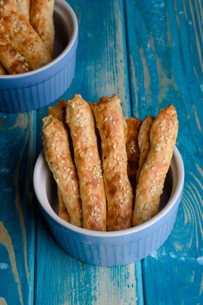 Fresh cottage cheese sticks with a sesame blue table