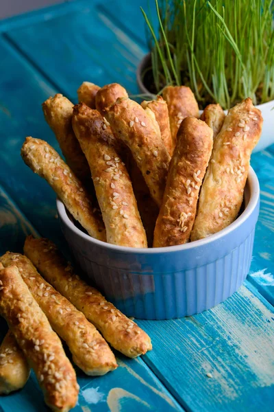 Fresh cottage cheese sticks with a sesame blue table