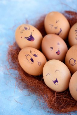 Paskalya yumurtaları mavi bir arka plan üzerinde komik küçük eşek. Yumurta farklı yüzleri. Duygular. Grims. Emoji.