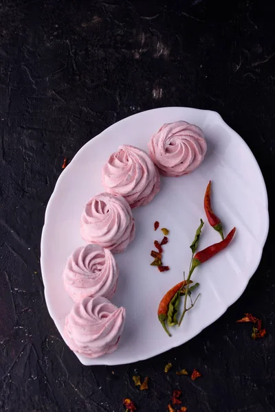 Spicy dessert with red pepper. Marshmallow Delicious and appetizing marshmallow with taste of red pepper on a black background.