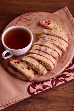 Kurutulmuş kiraz ve fındık ile siyah çay ve beyaz fincan lezzetli bisküvi kurabiye. Organik tarzı. Beyaz fincan çay.