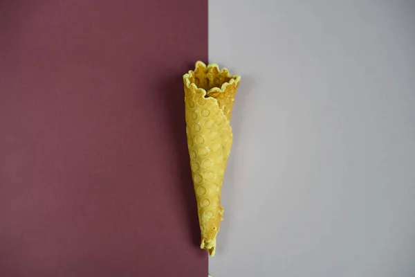 Waffle cone on colored geometric shapes