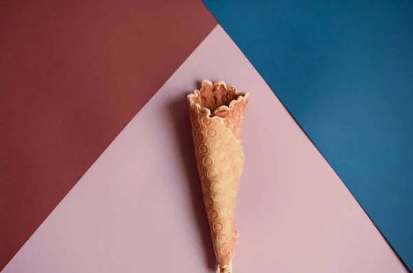 Waffle cone on colored geometric shapes