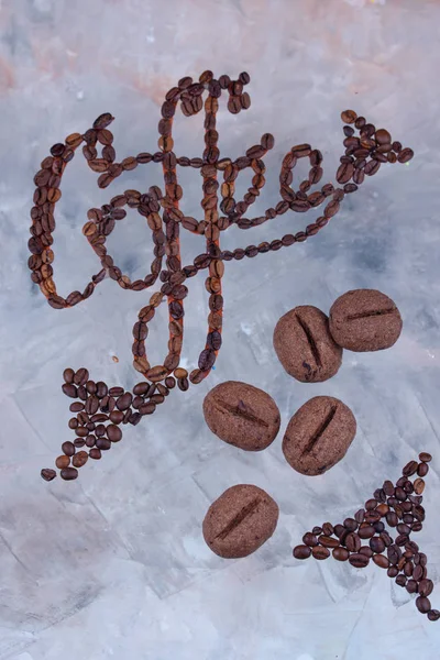 Delicious and fragrant coffee in the form of coffee, with grains of coffee, and the inscription on a light background.