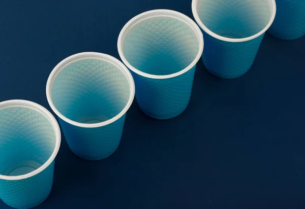 Plastic cups on a blue background