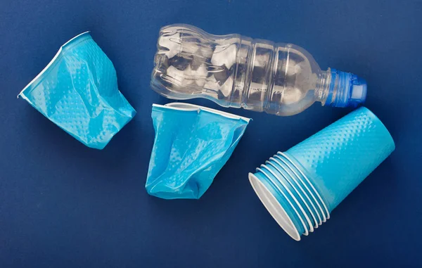 Plastic cups on a blue background