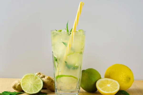 Cooling lemonade with lemon and lime, slices of ginger and mint leaves. — Stock Photo, Image