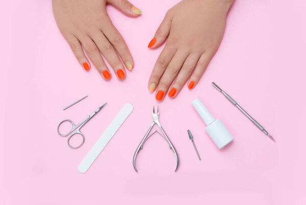 Beautiful well-groomed female hands, after manicure and and manicure tools.