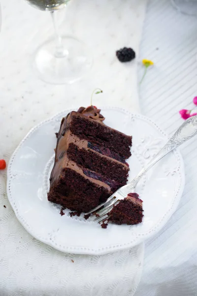 Delicious chocolate cake, red velvet in a glass, wild flowers, berries.