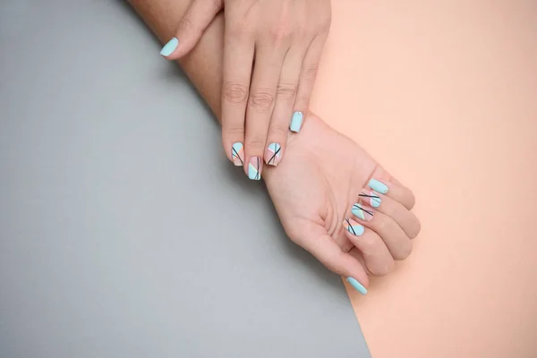 Beautiful female manicure on a pastel color background. — Stock Photo, Image