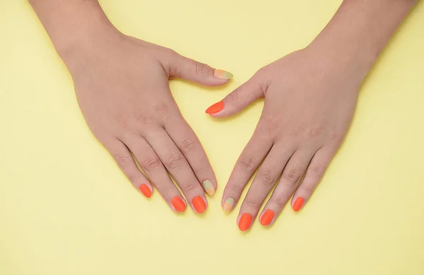 Mooie vrouwelijke manicure op een pastelkleurige achtergrond. — Stockfoto