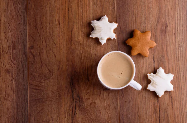 Biscotti di pan di zenzero di Natale su uno sfondo di legno con caffè aromatico e bastoncini di cannella — Foto Stock