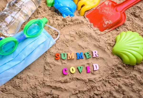 Beach sand, children\'s sand toys, face masks. Summer coronavirus. Covid-19. Stay home
