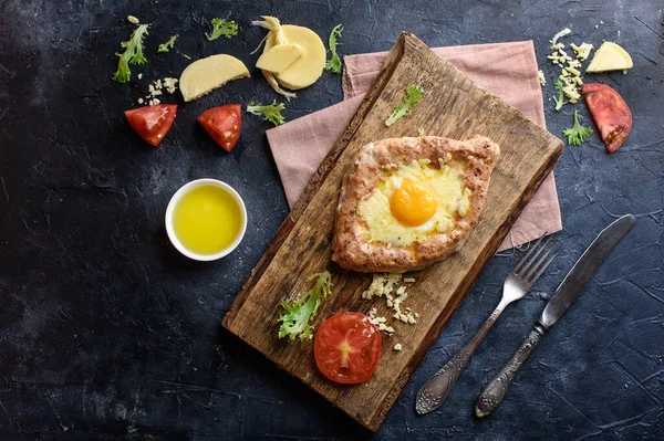 Peynirli, yumurtalı, tahıl unlu, kır evindeki süzme peynirli mis kokulu khachapuri. Düzgün bir yemek ve lezzetli bir kahvaltı.