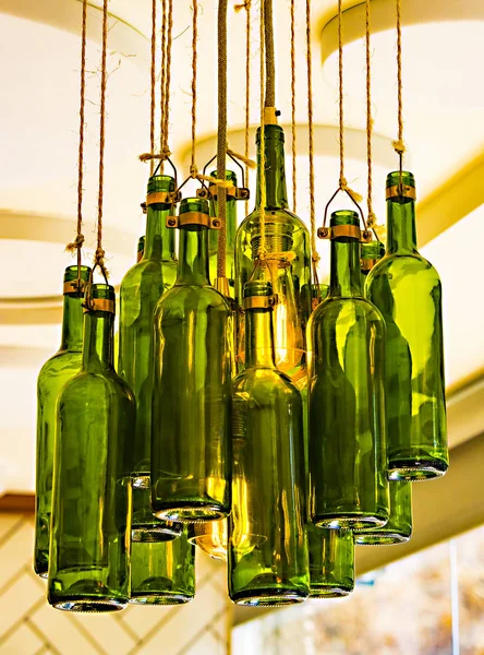 Lamps from old wine bottles against the ceiling