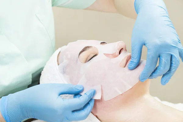 Woman on face massage and facial peels procedure at the salon cosmetics