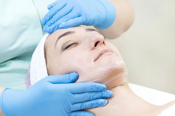 Woman on face massage and facial peels procedure at the salon cosmetics