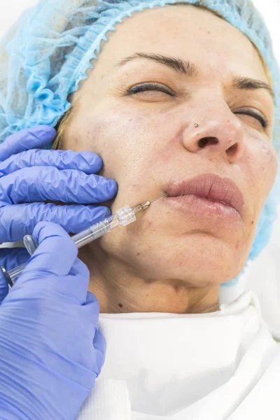 Cosmetic surgery, medicine procedure for an adult woman in a cosmetology clinic.