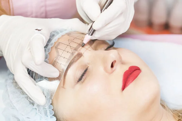 Microblading eyebrows workflow female eyebrowsin a beauty salon