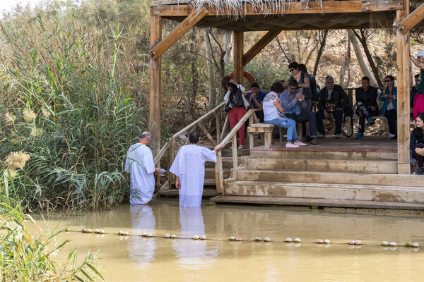 BETHABARA, ISRAEL- 25 NOVEMBER 2017: Pilgrims from different countries accept the rite of baptism in the Jordan River in Israel 