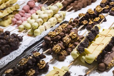 Meyve muz, çilek, fındık, elma, şeftali beyaz ve koyu çikolata sırılsıklam.