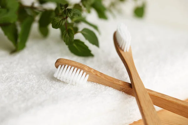 Two bamboo toothbrushes on white towel — Stock Photo, Image