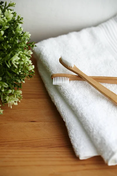 Two bamboo toothbrushes on white towel — Stock Photo, Image