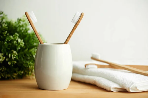 The bamboo toothbrushes in a gray glass with copy space — Stock Photo, Image