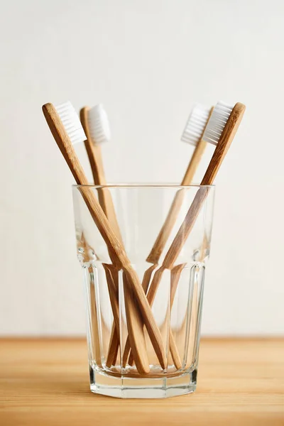 Four bamboo toothbrushes in a glass — Stock Photo, Image