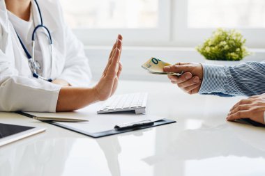 Genç doktor hastasından rüşvet almayı reddediyor.