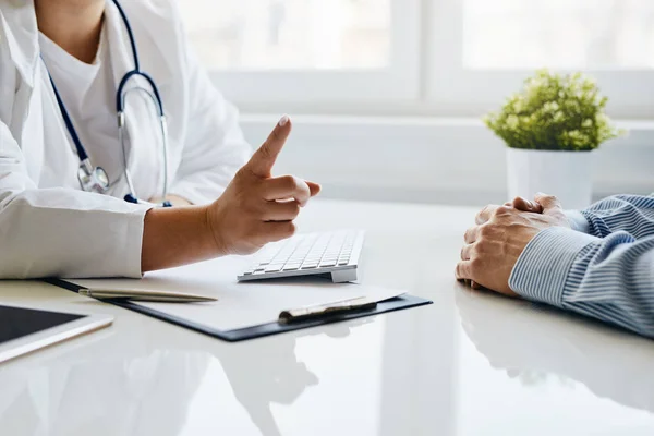 Female doctor warns her patient with a raised finger