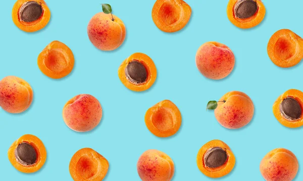 Top view of fruit pattern of ripe apricots on blue background — Stock Photo, Image