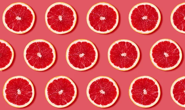 Fruit pattern from grapefruit on red background