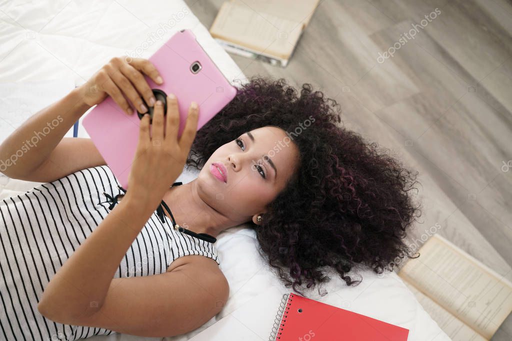 Hispanic Girl Using Digital Tablet For School Homework