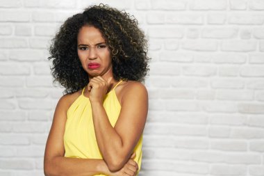 Facial Expressions Of Young Black Woman On Brick Wall clipart