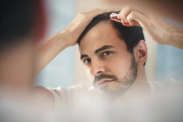 Hair Shedding vs Hair Loss Treatment Dermatologist | Stock Photo