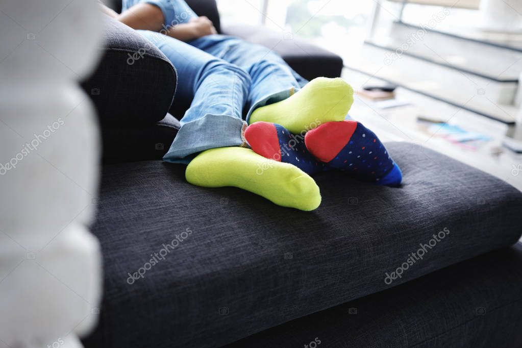 Young Man and Woman Kissing Holding Hands on Sofa