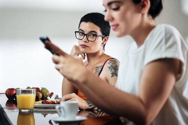 Jealous Lesbian Woman Looking at Partner Messaging On Social Media