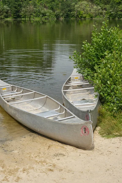 小池塘海滩上的两艘铝制独木舟 — 图库照片