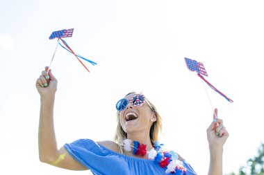 A patriotic blonde model having fun during the 4th of July holiday.   clipart