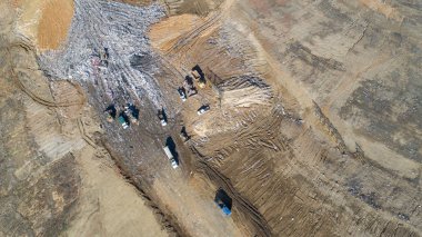 Birden çok damperli kamyonlar tarafından hizmet verilen bir ilçe çöp dökümü havadan izleme