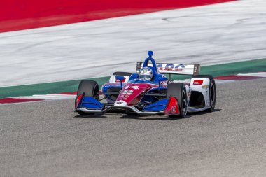 Tony Kanaan (14) Brezilya uygulamaları sırasında döner devre Of Americas Austin, Teksas, IndyCar bahar Test için geçer.