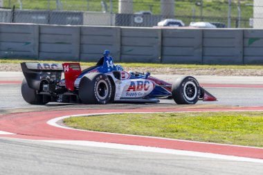 Tony Kanaan (14) Brezilya uygulamaları sırasında döner devre Of Americas Austin, Teksas, IndyCar bahar Test için geçer.