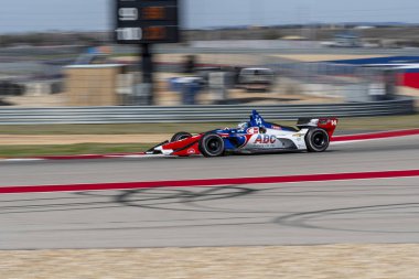 Tony Kanaan (14) Brezilya uygulamaları sırasında döner devre Of Americas Austin, Teksas, IndyCar bahar Test için geçer.