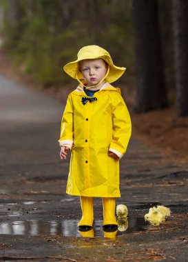 Onun galoş yağmurda zevk çocuk 