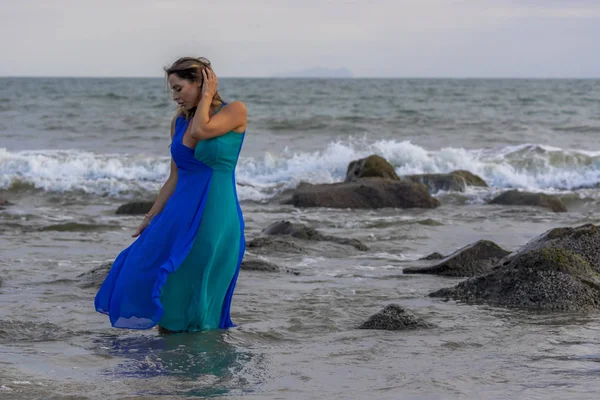 Härlig brunett latinska modellen utgör utomhus på en strand vid solnedgången — Stockfoto