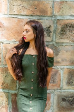 Muhteşem bir esmer model, açık havada bir bahar gününün tadını çıkarıyor. 