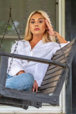 Sarışın bir model yaz gününün tadını çıkarırken dışarıda poz veriyor.