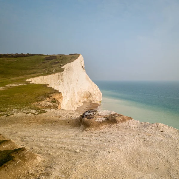 White chalk cliffs of Seven Sisters, Sussex, England. Aerial view of the coast on the south of England with the chalk cliffs of Seven Sisters looking out into the English Channel near the Birling Gap.