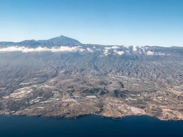 An aerial view towards the east coast of the Canary Island of Gran Canaria showing the changing geography from the coast and plains rising to the interior mountains.